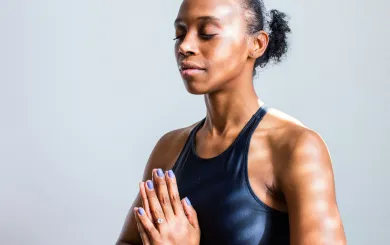 woman doing a breathing technique in a well lit room