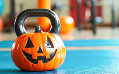 a kettlebell shaped like a pumpkin on the gym floor