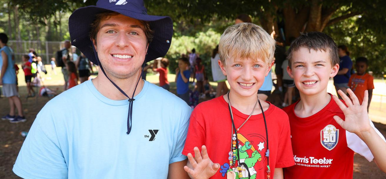 Two boys with a counselor at day camp