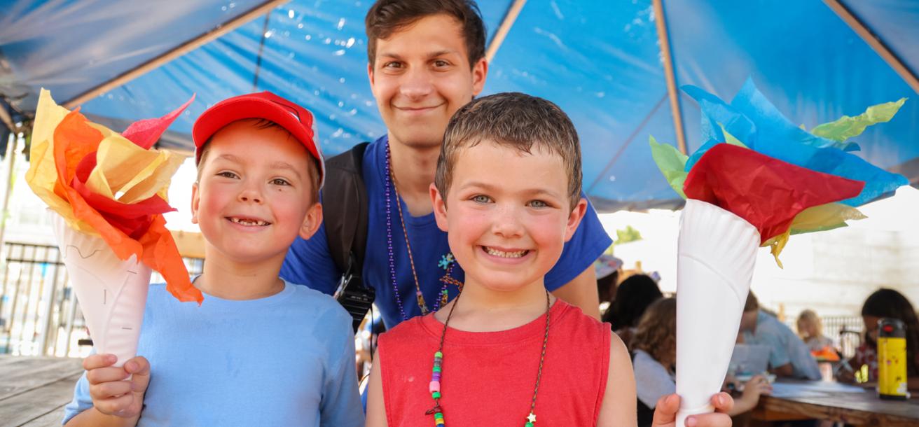 Kids showing off their finished crafts at YMCA day camp.