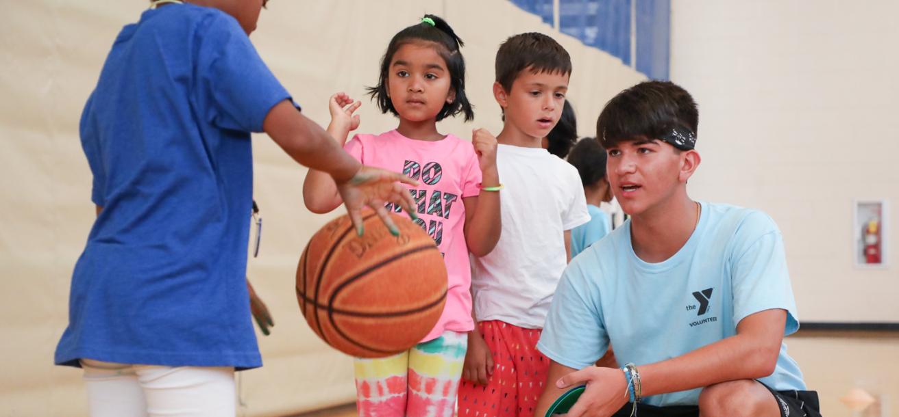 Kids practicing their dribble at basketball camp