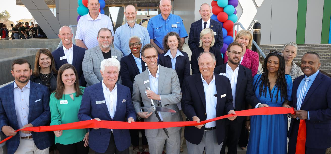 Group cutting the ribbon at the Chatham Park YMCA (March 2025)