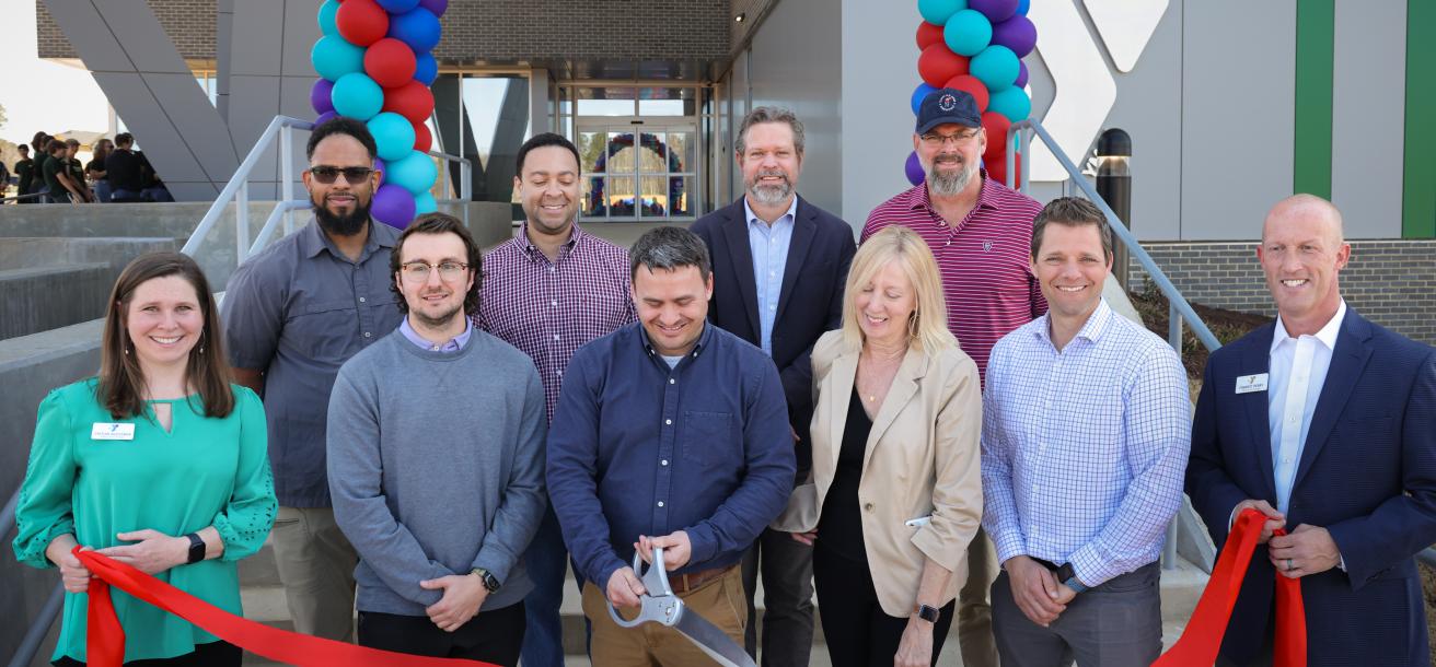 Group cutting the ribbon at the Chatham Park YMCA (March 2025)