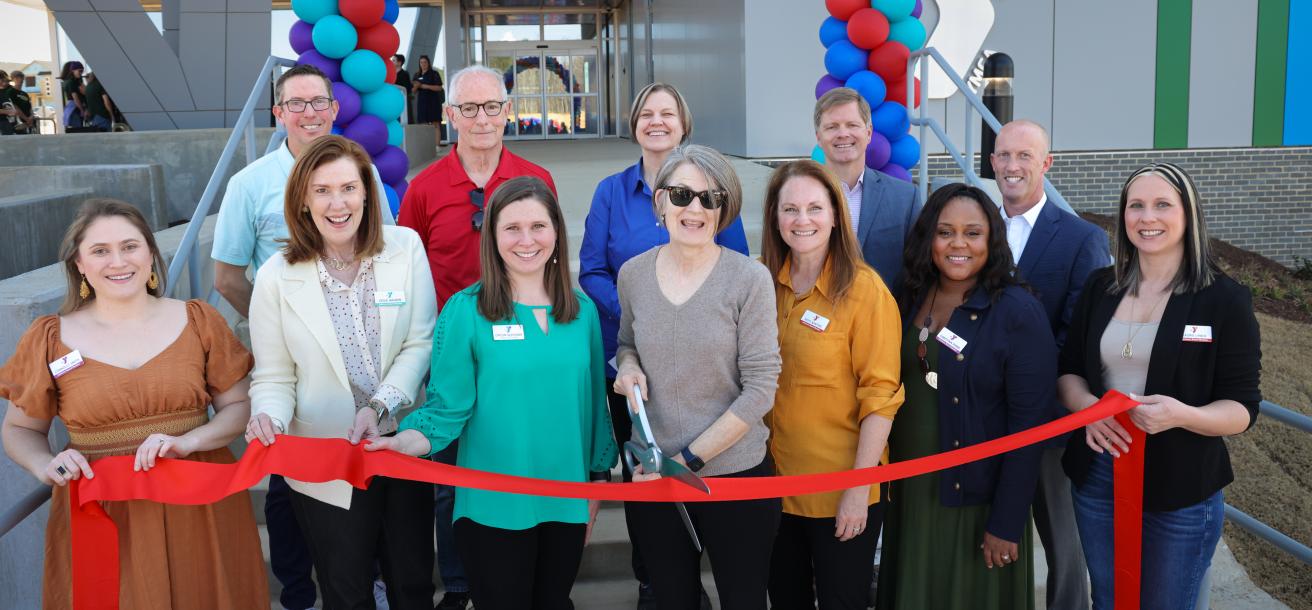 Group cutting the ribbon at the Chatham Park YMCA (March 2025)