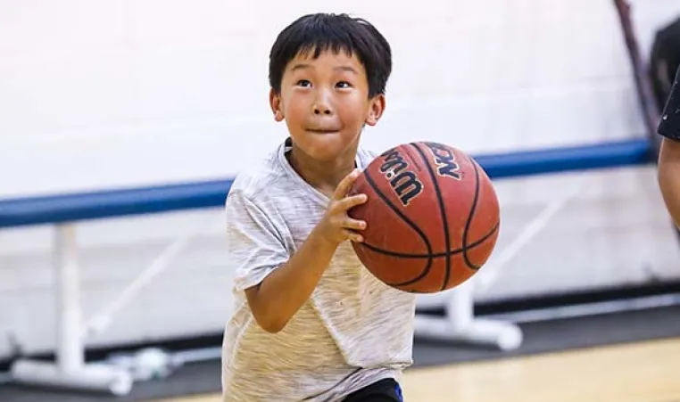 Young boy playing basketball