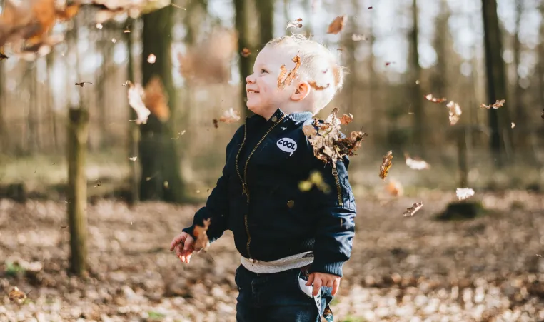 toddler with leaves