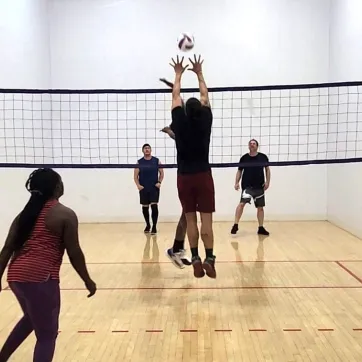 Wallyball player blocks the shot