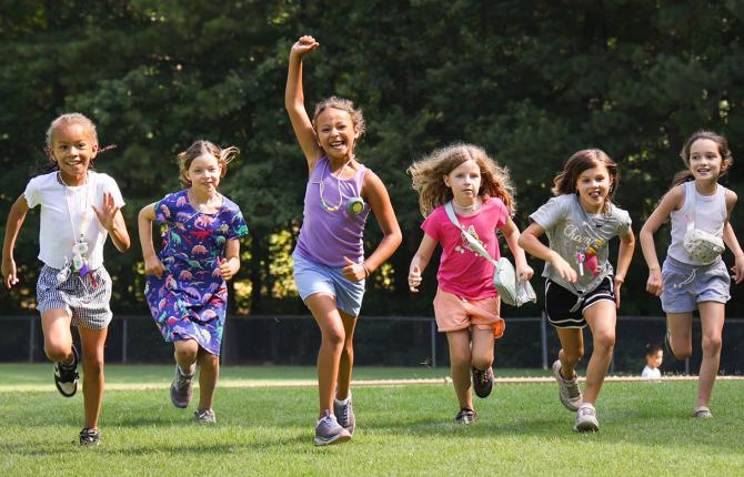 Group of girls running and smiling