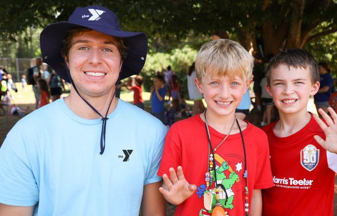 Two boys with a counselor at day camp
