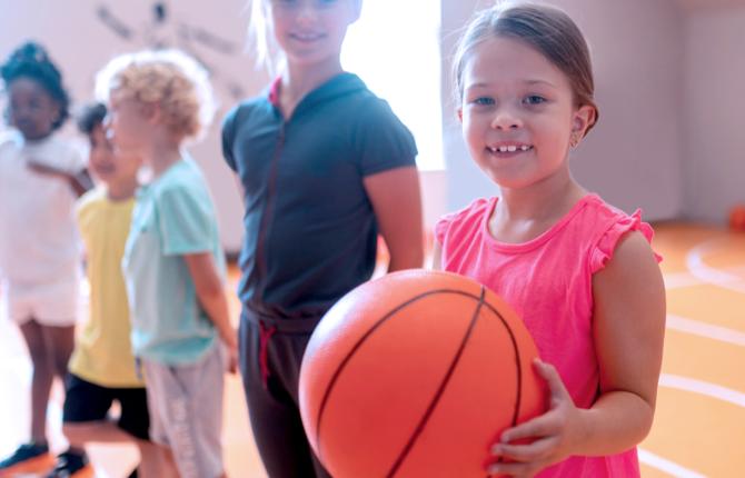Young kids leaning basketball skills
