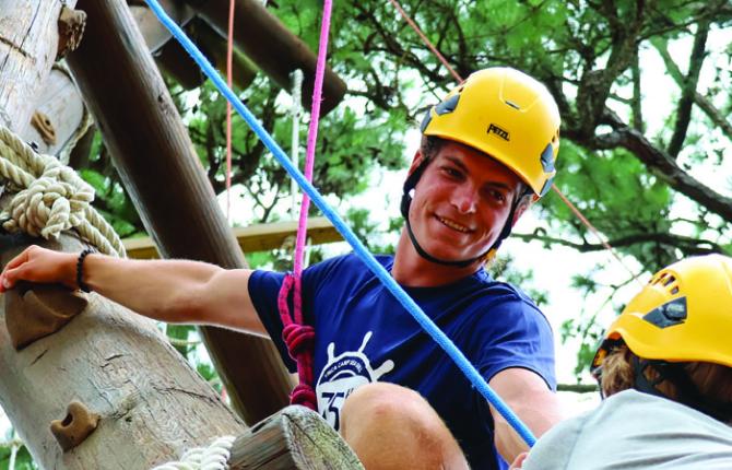 Overnight camp counselor on the ropes course at YMCA Camp Sea Gull