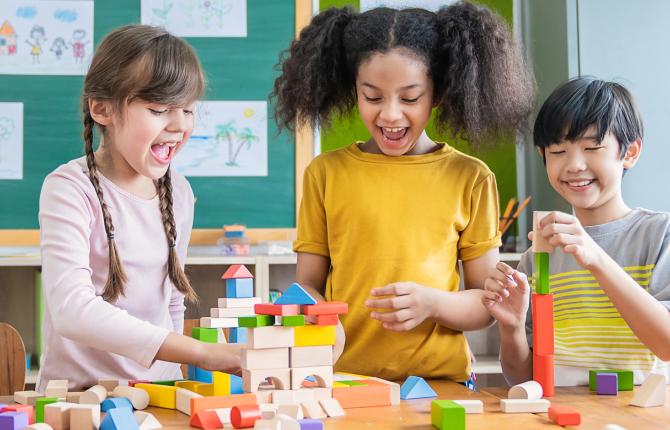 Three kids building a city with blocks