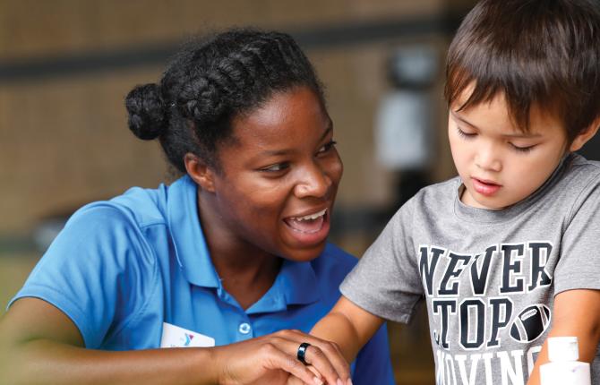 Counselor helping a child with an art project