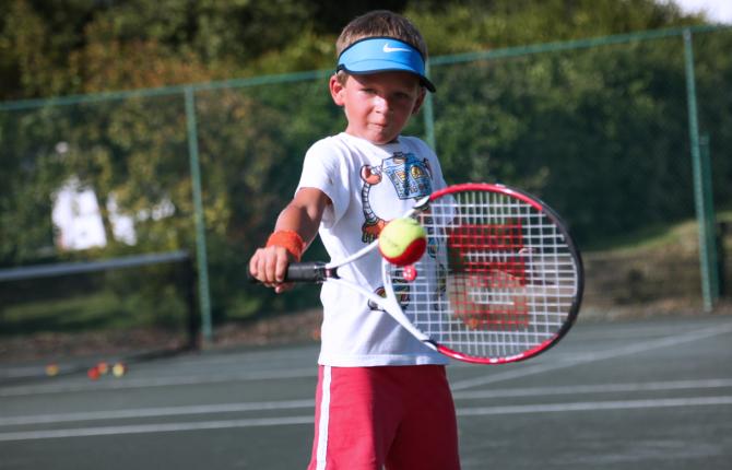 Boy practicing tennis