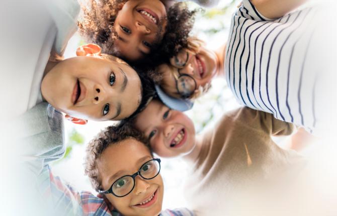 Group of smiling kids in a huddle