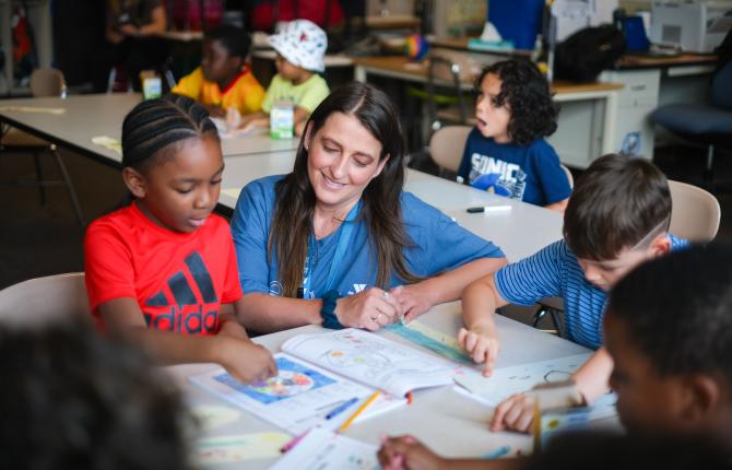 Children work on their reading and math skills with their teacher at YMCA Power Scholars