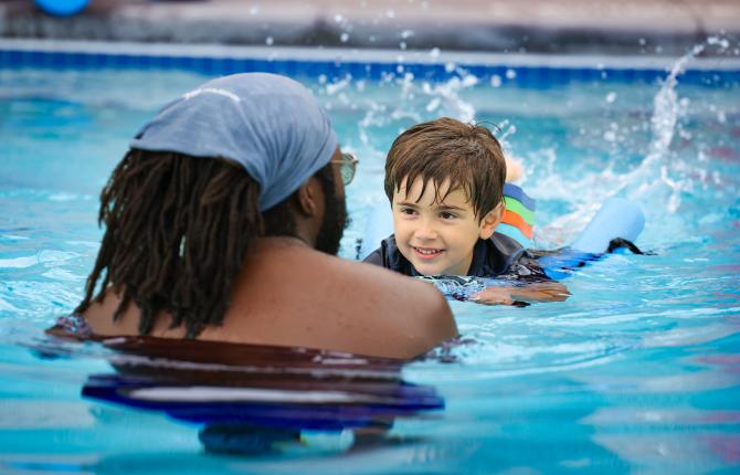 Young boy receives a swim lesson as part of YMCA Swim for Life